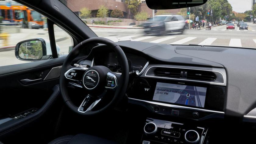 FILE PHOTO: A self-driving Waymo car drives through Los Angeles