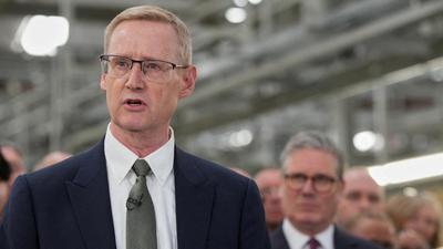 FILE PHOTO: Outgoing CEO of Jaguar Land Rover,  Adrian Mardell, speaks as Britain’s Prime Minister Keir Starmer, looks on